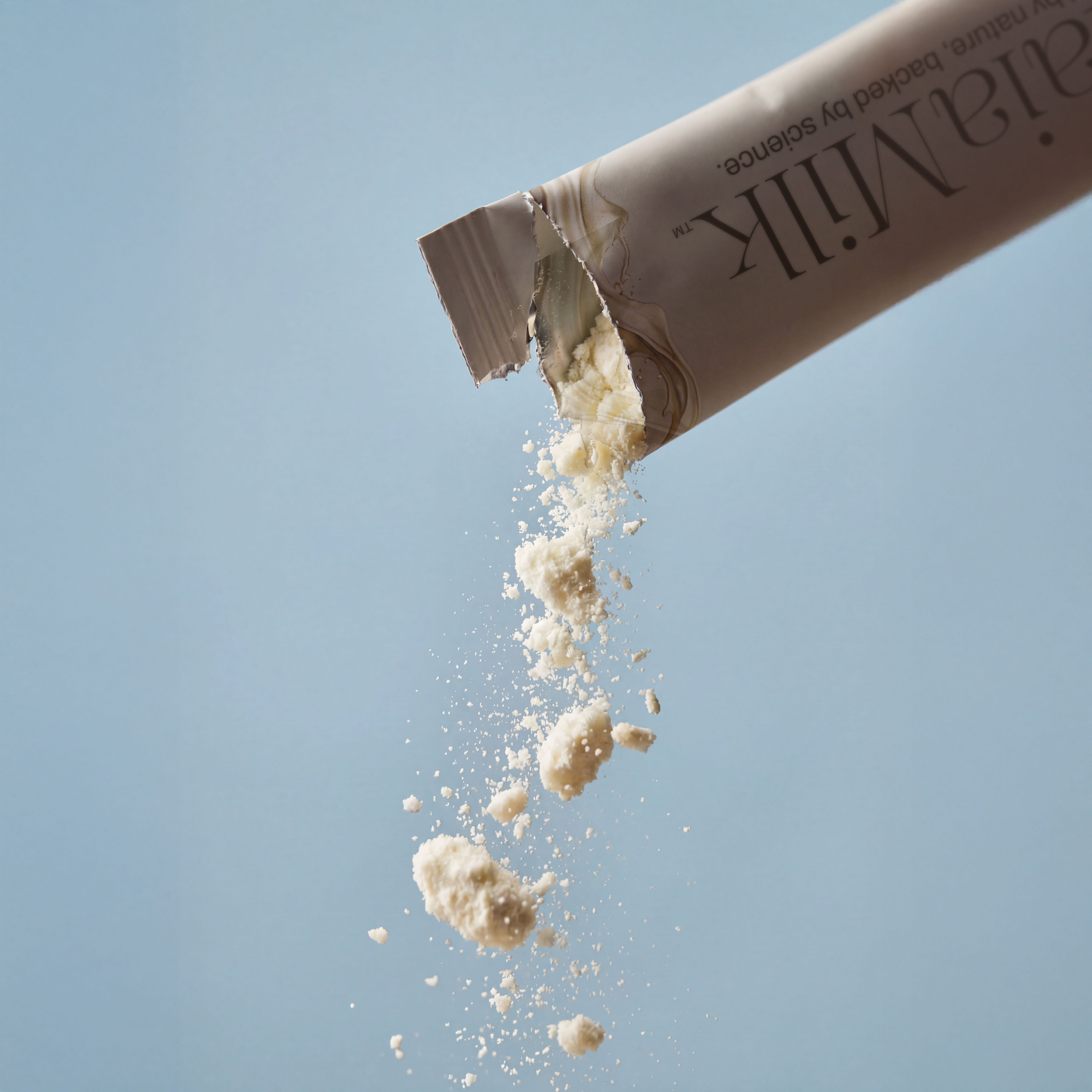 MaiaMilk product being poured with a clear blue background